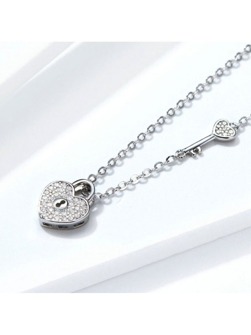 An elegant 925 Sterling Silver heart pendant that is a lock, AAAA CZ's